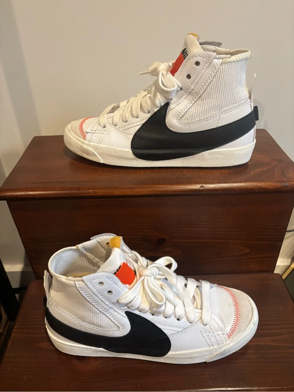Nike White High-Top Sneakers with Black Swoosh and Orange Tongue Tab